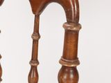 a close up of a wooden chair with a wooden seat