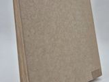 a close up of a piece of brown paper on a white surface