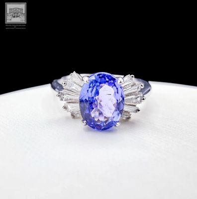 a picture of a tanzane and diamond ring on a white plate