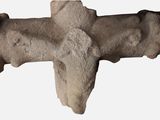 a stone cross on a white background with a shadow