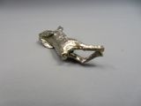 a metal object that looks like a dog laying down