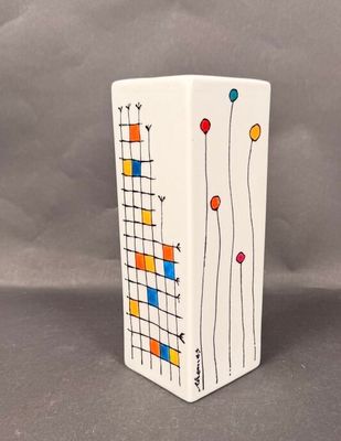 a white vase with a colorful design on it