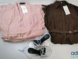two shirts and a pair of shoes sitting on a table