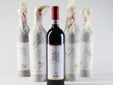 three bottles of wine that are sitting next to each other