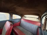 a red and black seat in the back of a car