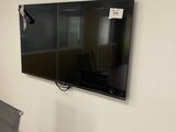 un téléviseur à écran plat fixé au mur d'une pièce