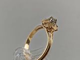 a close up of a gold ring with a flower on it