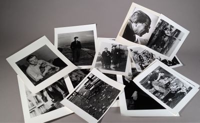 many black and white photographs of people on a table