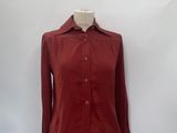 a mannequin with a red shirt on a white mannequin stand