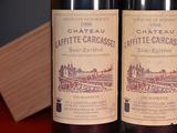 two bottles of wine sitting next to each other on a table