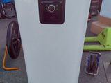 an image of a white refrigerator in the middle of a yard