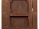 an old wooden cabinet with two shelves and a label on the door