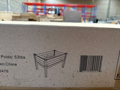 packaging for a wooden bench in a warehouse with a barcode on it