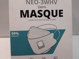 the box is open on the table with a white mask in it