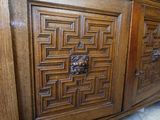 a wooden cabinet that has a door and a drawer on top of it