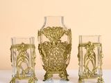 three glass vases sitting next to each other on a table