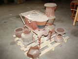 many pots and pans on a pallet in a garage
