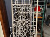 an old white iron screen with a decorative design on it