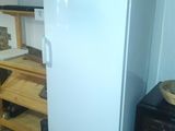a white refrigerator sitting in a kitchen next to a counter