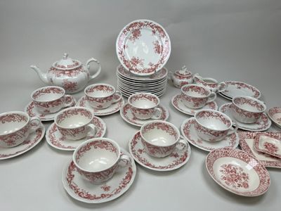 many plates and cups and saucers on the table
