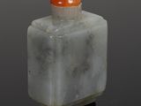 chinese jade snuff bottle with an orange top