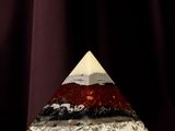 an image of a pyramid shaped object on a purple cloth