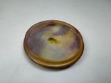 a brown and yellow object on a white surface