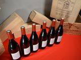 several bottles of wine are lined up in a row on a table