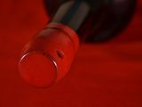 a close up of a bottle of wine on a red cloth