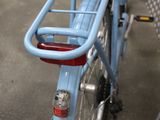 a blue bicycle with a basket on the back of it