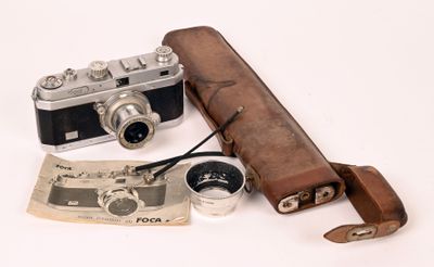 a leather case with a camera and a pair of binoculars