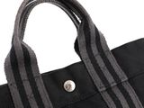black canvas tote bag with grey stripes and a button