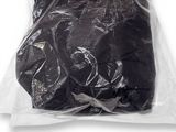 a bag of black clothing on a white surface