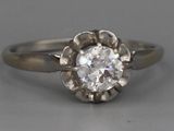 a close up of a diamond ring on a table