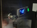 a clock that is on the side of a machine