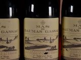 three bottles of wine sitting on top of a wooden table