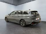 the rear end of a silver car in a showroom