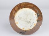 a brown and white vase with a brown lid