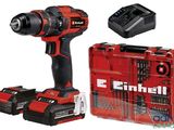 une perceuse sans fil et deux batteries dans un étui