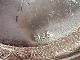 a close up of a silver plate with a clock on it