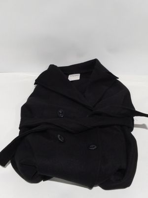 the back of a black jacket with buttons on it sitting on top of a white surface