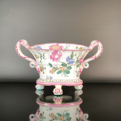 a pink and white bowl with flowers on it