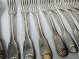a lot of spoons and forks that are on a table