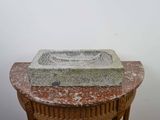 a stone sink sitting on top of a table