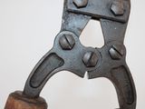 an old rusty pipe cutter on a wooden stand
