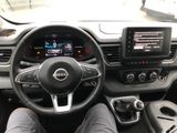 someone is sitting in the driver ' s seat of a car with their feet on the steering wheel