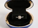 a blue box with a diamond ring inside of it