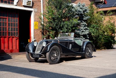 a black car parked in front of a building