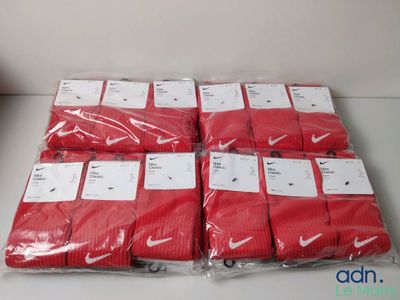 plusieurs paires de chaussettes Nike rouges posées sur une table blanche
