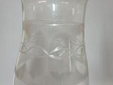 a glass vase with a design on it next to a glass vase